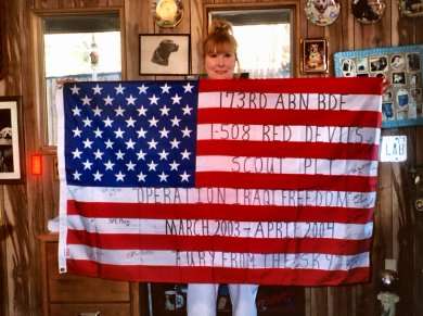 Sheryl with her flag from the 173rd Red Devils.